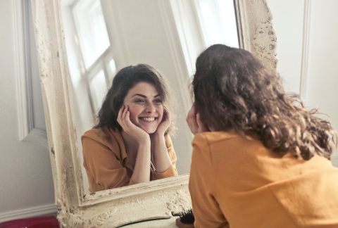 Photo by Andrea Piacquadio: photo of woman looking at the mirror