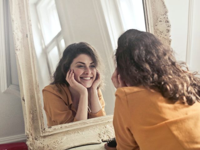 Photo by Andrea Piacquadio: photo of woman looking at the mirror