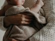 Photo by Kristina Paukshtite: woman carrying a baby